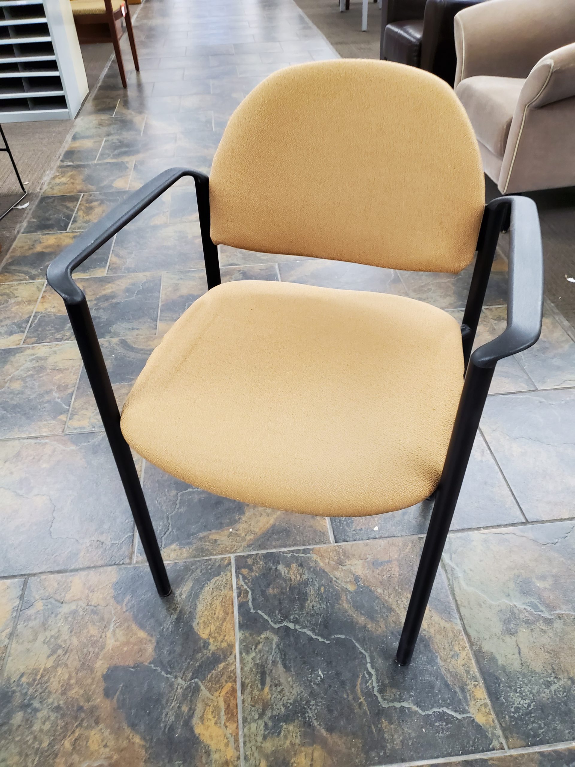 brown leather chair with grey couch